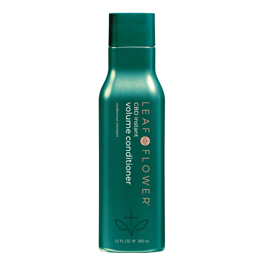 A bottle of LEAF and FLOWER Instant Volume Conditioner with a fuller appearance on a black background.