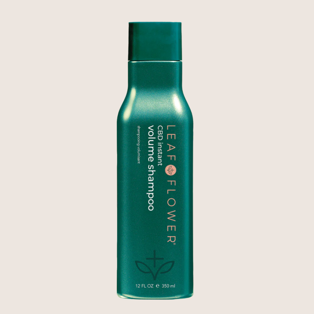 Green bottle of Leaf and Flower Instant Volume Shampoo, available in multiple sizes, crafted for hair health with its plant-based formula.