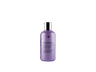 A bottle of Oligo Blacklight Nourishing Shampoo on a black background.