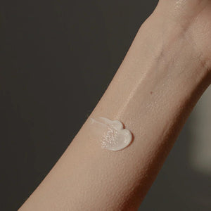 A close-up of a forearm with Oway After Sun Body Balm applied to sun-exposed skin. The plain background and soft lighting highlight the balm’s texture, emphasizing the soothing, hydrating care from Oway.