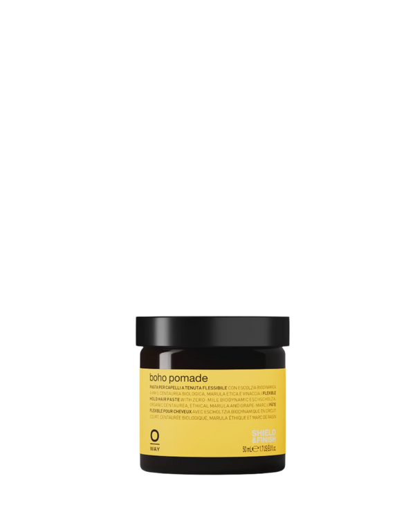A 50 ml dark brown jar with a black lid and yellow label displays "Oway Boho Pomade | Texturizing Cream Pomade for Laid-Back, Matte Finish," offering flexible hold with biodynamic marrubium and detailed info on the label.