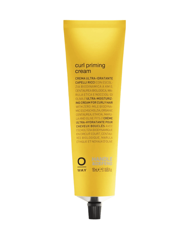 A yellow tube of Oway Curl Priming Cream | Moisture-Rich Curl Primer for Frizz-Free Styling with black text and a metallic cap is set against a textured green background. Its Marula Oil-infused details are printed in several languages on the packaging.