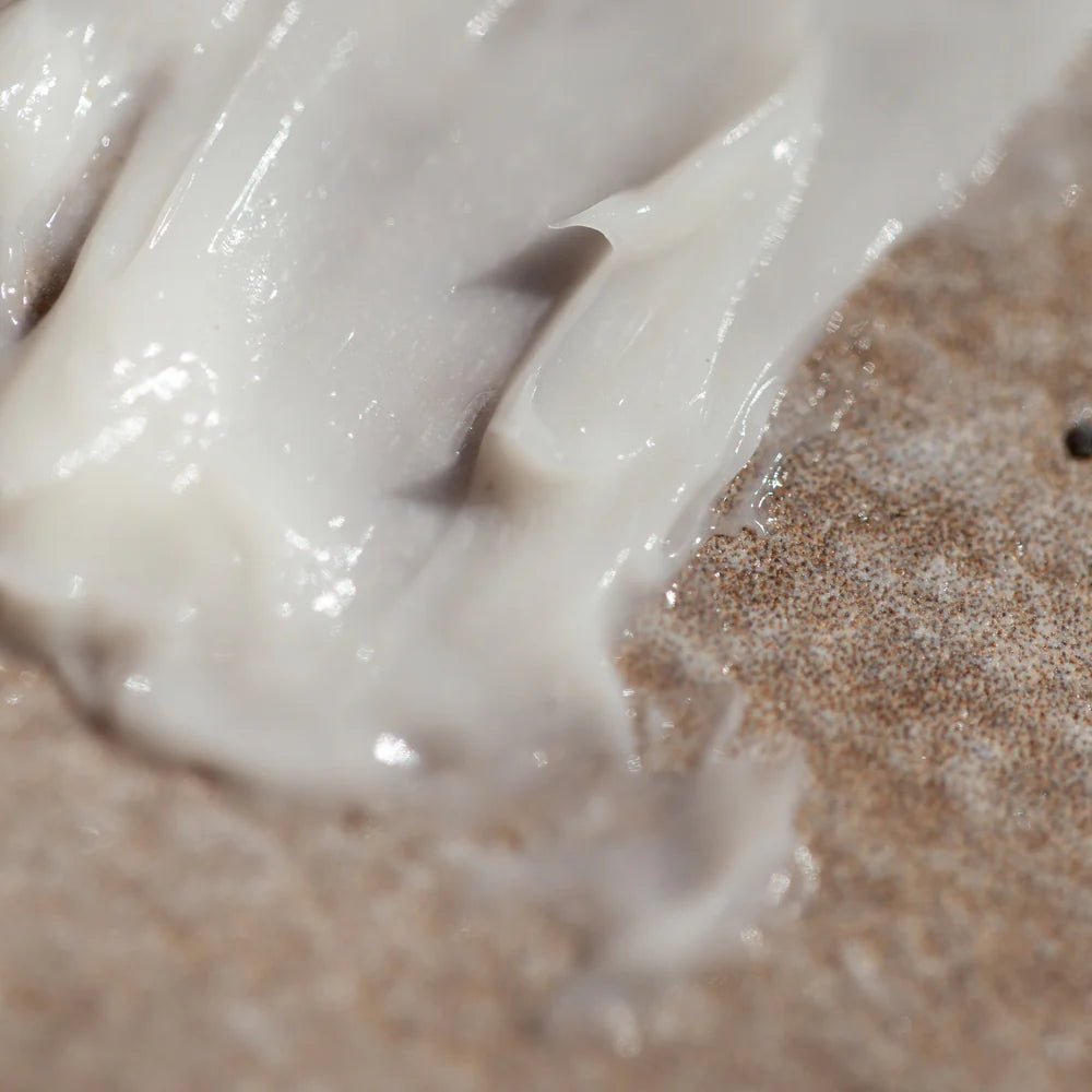 Close-up of Oway Curly Hair Mask | Definition and Moisture Mask for Natural Curls spread on a textured brown surface, ideal for nourishing and defining natural curls.