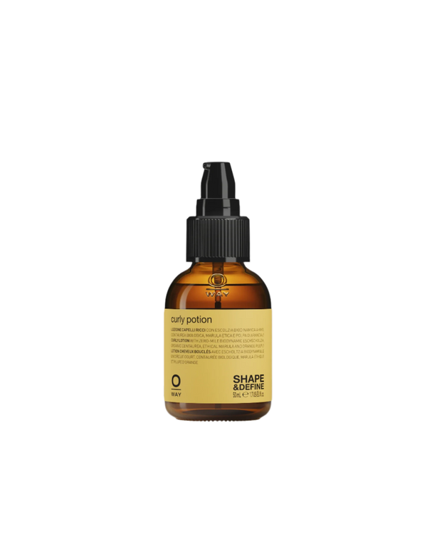 A small amber bottle with a black pump dispenser and yellow label, Oway Curly Potion is a curl-defining serum that shapes curls for soft, shiny hair while delivering superior frizz control.