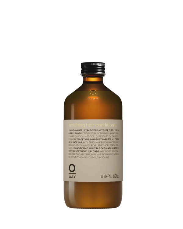 A brown bottle with a black cap labeled "Oway Enriching Hair Conditioner | Ultra Detangling For Dry Brittle Strands" (240 ml/8.5 fl. oz.) stands upright on a white background, boosting natural shine for all hair types.