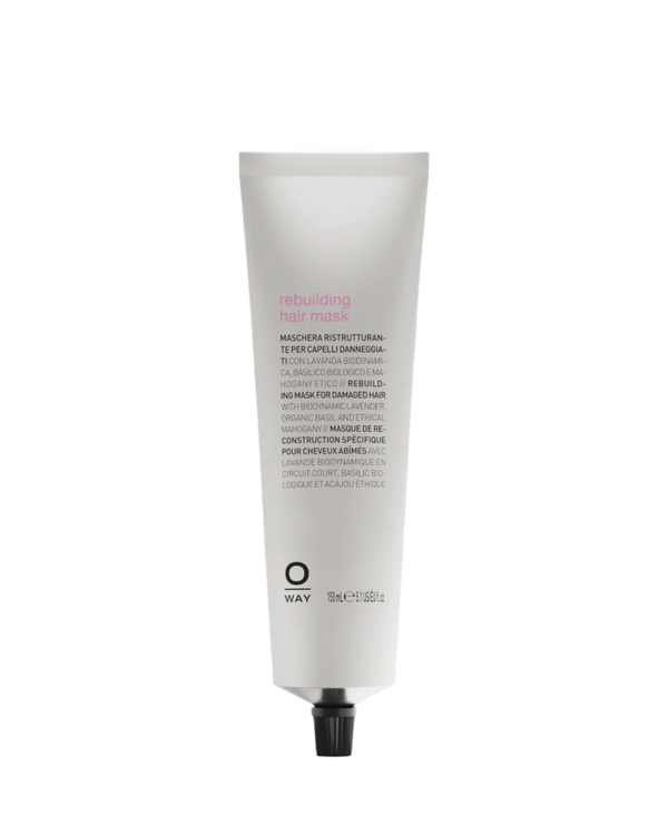 A white upright tube of Oway Rebuilding Hair Mask | Restorative Mask for Damage and Instant Repair has a black cap and multilingual product details printed on the front, highlighting its restorative benefits for damaged hair.