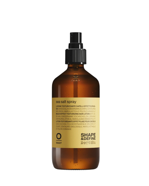 A brown spray bottle with a yellow label featuring "Oway Sea Salt Spray | Beachy Texture Spray for Tousled Waves" by Oway. The label provides multilingual details—ideal for creating effortless, tousled waves and beachy texture.