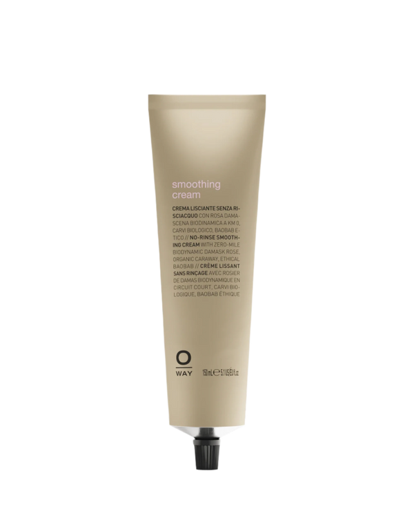 A beige tube labeled "Oway Smoothing Cream | Blow Dry Cream for Sleek, Straight Styles" with black text and cap stands upright on a white background. Designed to tame frizzy hair, it contains organic caraway. The "Oway" brand appears near the bottom.