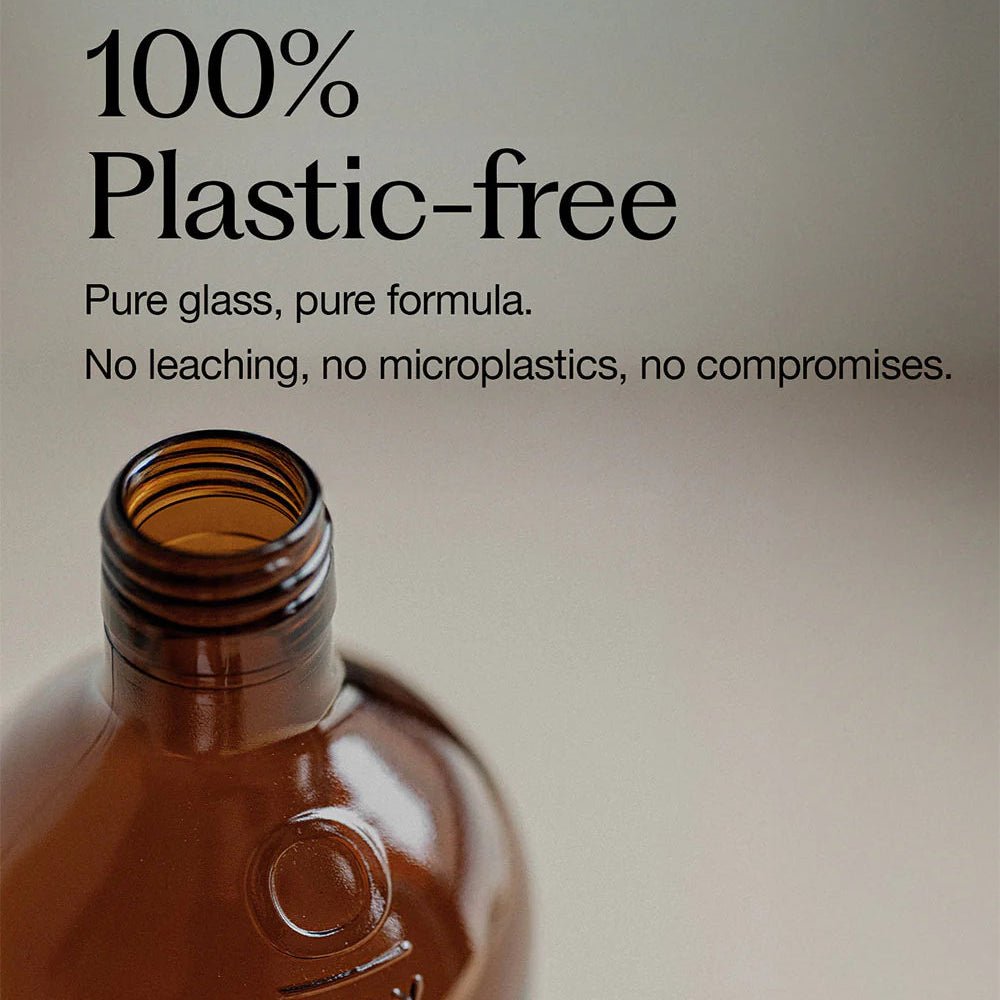 Brown glass bottle with '100% Plastic-free' text on a light background