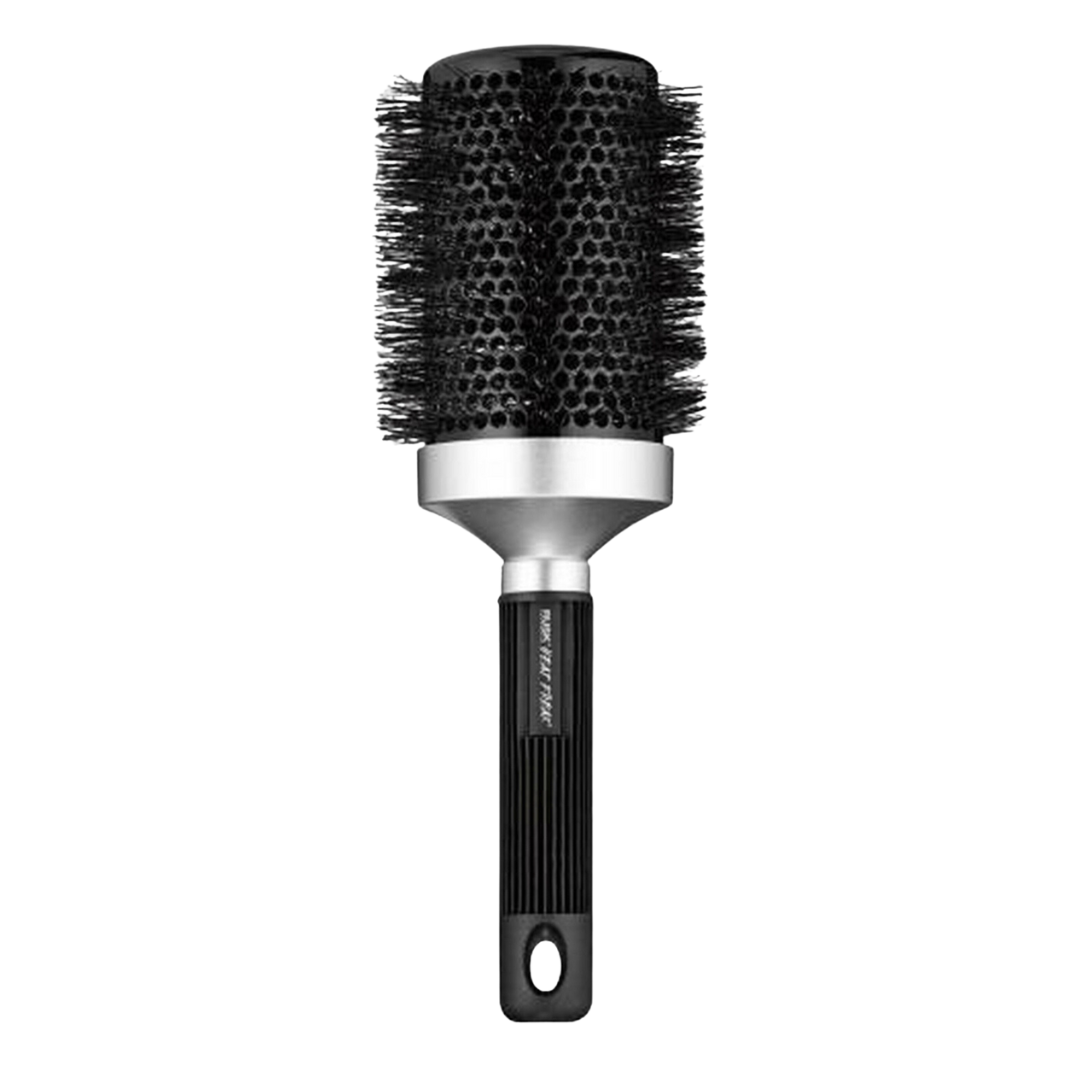 A RUSK Round Brush for styling hair on a black surface.