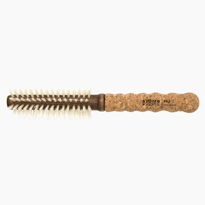 Round brush with cork handle on a white background