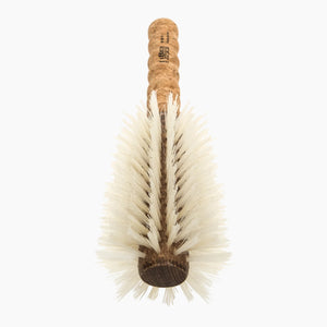 Bristle brush with cork handle on a white background