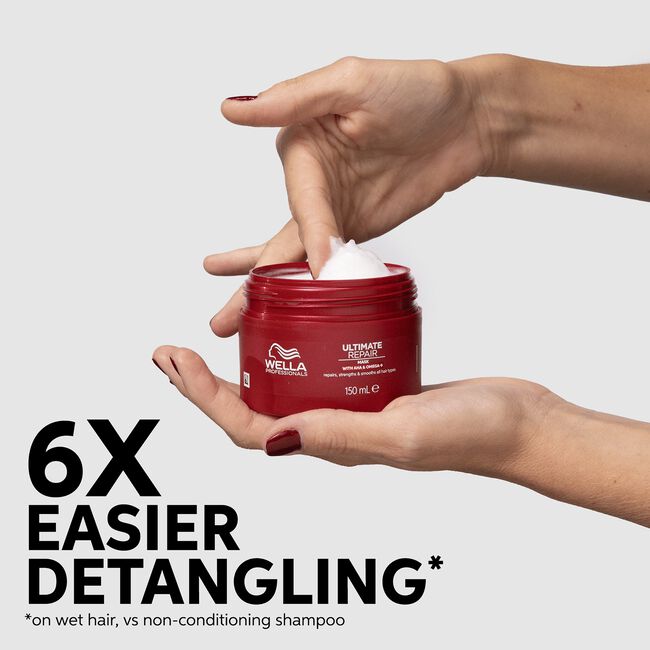 Red Wella hair product jar with hands opening it on a light gray background