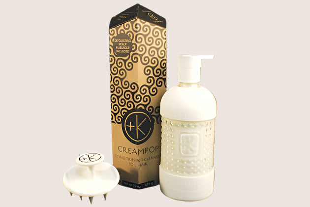 Here is an image of the Cult and King CREAM POP | Conditioning Cleanser for Hair. The set comprises a bottle with a pump dispenser, an applicator with a handle, and packaging featuring a wavy pattern design against a black background. This silicone-free conditioner from Cult and King ensures shiny hair with every use.
