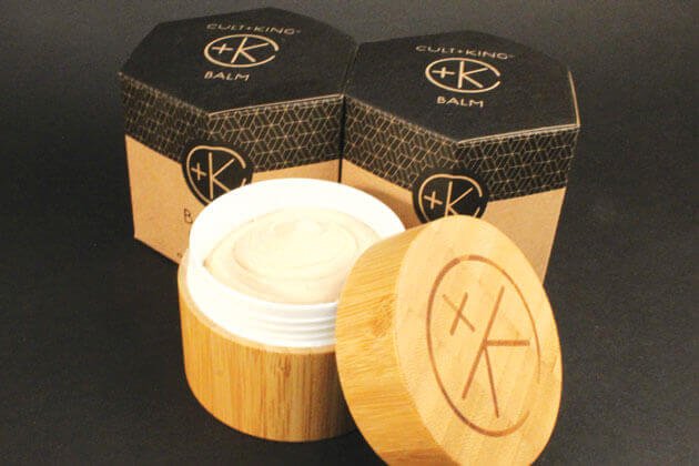 A wooden container with Cult and King BALM | Hair to Toe for skin and hair care.