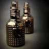 A pair of black Cult and King TONIK bottles with studs on them.
