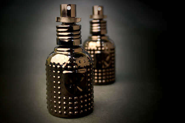 A pair of black Cult and King TONIK bottles with studs on them.