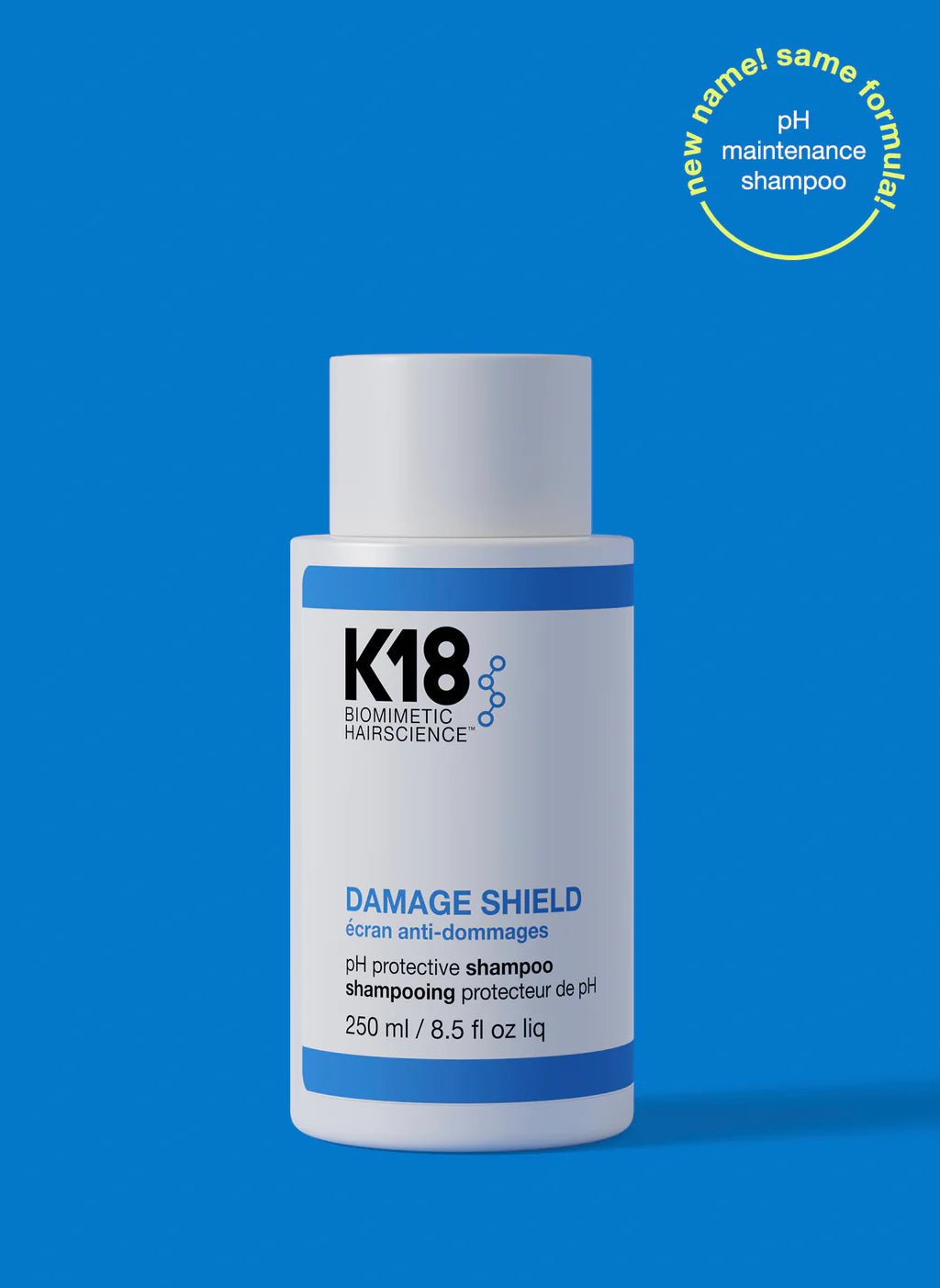 A 250 ml bottle of K18 DAMAGE SHIELD pH Protective Shampoo - Multiple Sizes by K18 Hair Repair is displayed against a blue background. A circular label at the top right reads "new name! same formula! pH maintenance shampoo," featuring K18PEPTIDE™ for daily use.