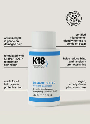 A white bottle of K18 Hair Repair DAMAGE SHIELD pH Protective Shampoo - Multiple Sizes stands upright, with text highlighting its pH-balanced, color-protective formula, PEPTIDE PREP™, and vegan ingredients.