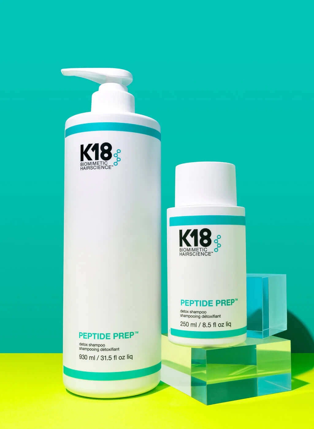 Two K18 Hair Repair bottles labeled "K18 PEPTIDE PREP Detox Shampoo - Multiple Sizes" against a teal background. The larger bottle holds 930 ml (31.5 fl oz) and the smaller bottle holds 250 ml (8.5 fl oz). This K18PEPTIDE™ formula offers a deep cleanse with a color-safe clarifying shampoo, perfect for maintaining vibrant, healthy hair.