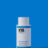 A white bottle labeled "K18 DAMAGE SHIELD pH Protective Shampoo - Multiple Sizes" stands against a blue background. This 250 ml (8.5 fl oz) cleansing shampoo, crafted with K18PEPTIDE™, is perfect for daily use to maintain optimal pH balance and hair health.