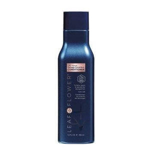 A dark blue bottle of Leaf and Flower Damage Correction Conditioner, available in multiple sizes, stands upright against a white background. The label displays product details and features silver and white branding.