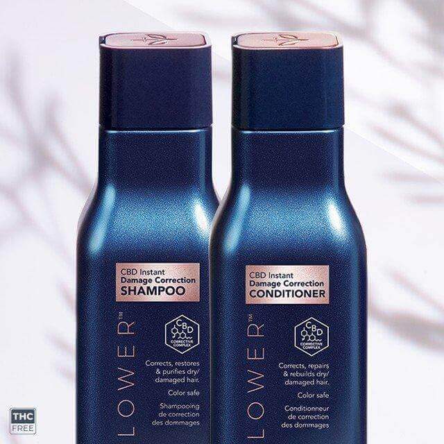 Two blue bottles labeled LEAF and FLOWER Damage Correction Shampoo and Conditioner, praised for frizz control and restoring damaged hair, marked THC-free, against a blurred background with shadow.