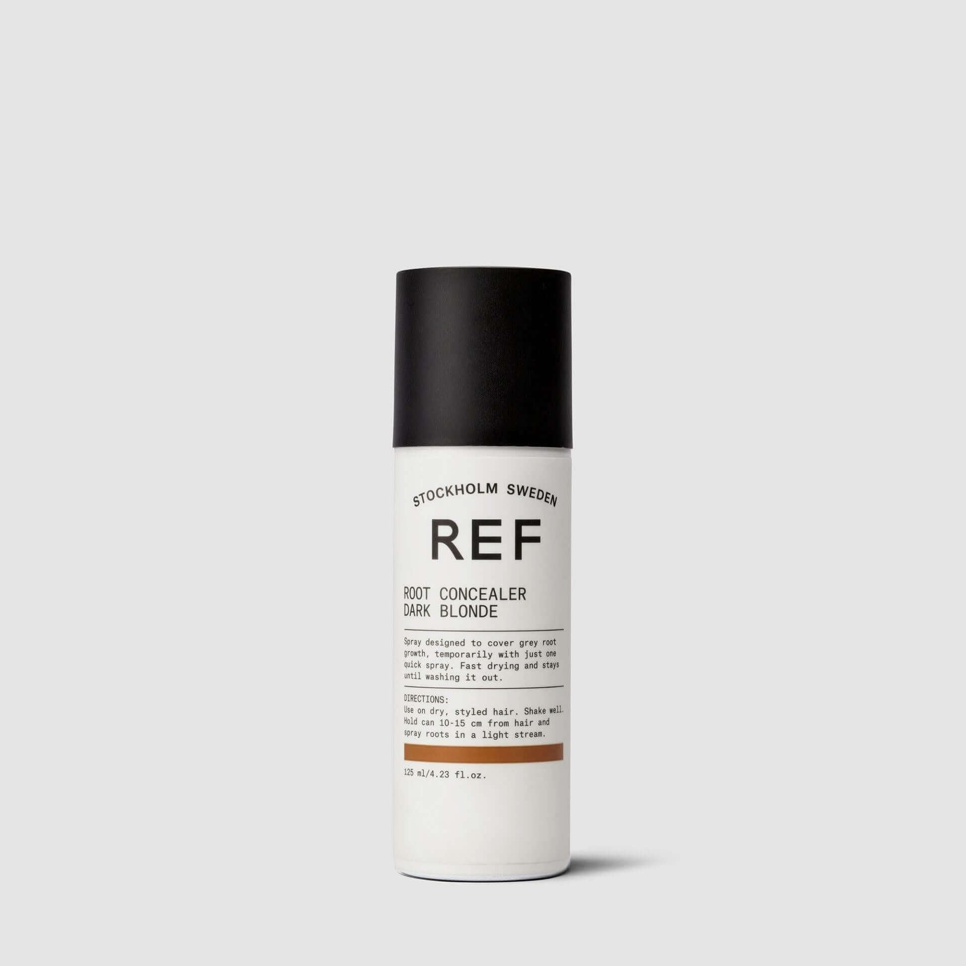 A bottle of REF STOCKHOLM SWEDEN Root Concealer on a white surface.