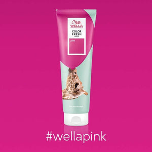 A tube of Wella Professional Color Fresh Mask in pink stands upright on a pink background, showing a giraffe on the packaging and #wellapink below—ideal for ultra-light blonde hair thanks to its ammonia-free formula. Brand: Wella.